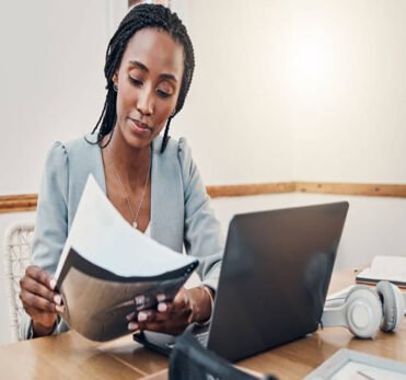 Black woman with business documents, small business entrepreneur working on strategy and planning online marketing. Learning startup industry vision, laptop for advertising company and technology job