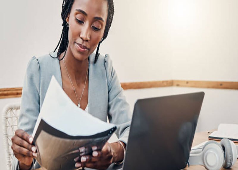 Black woman with business documents, small business entrepreneur working on strategy and planning online marketing. Learning startup industry vision, laptop for advertising company and technology job